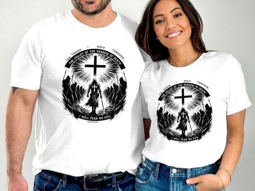 Two people wearing matching white t-shirts with a black graphic featuring a cross.